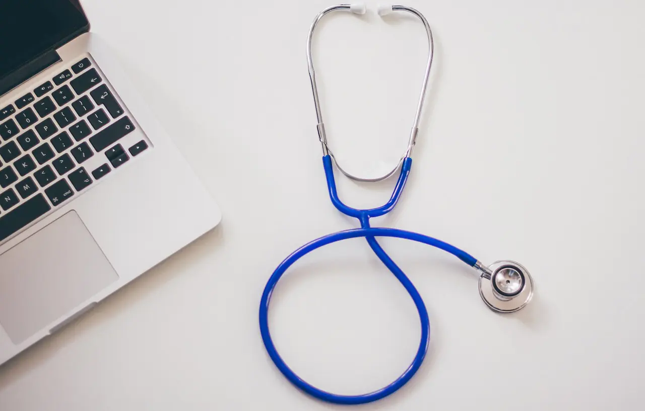 Stethoscope and laptop on a table